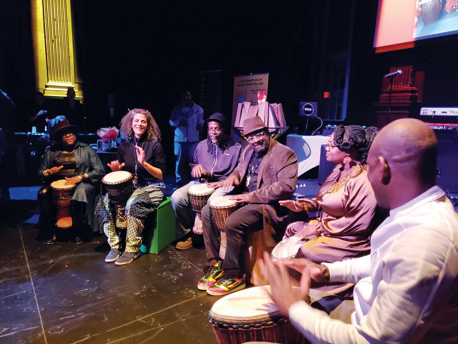 DJEMBEFOLA: Djembe player Sidy Maïga (right) leads a drum circle at the Funda Fest 26 opening party at Rites and Reason Theatre with (right to left) Rachel Briggs, Marlon Carey, Len Cabral, Valerie Tutson, and Shavon ChocIt Smith.